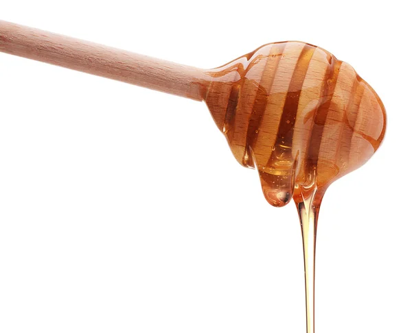 Honey dripping from a honey dipper — Stock Photo, Image