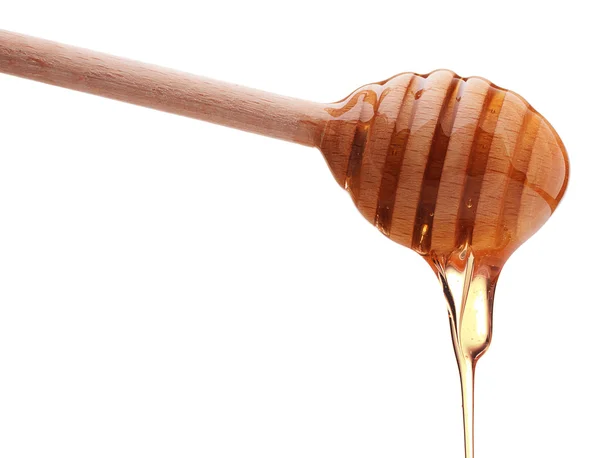 Honey dripping from a honey dipper — Stock Photo, Image