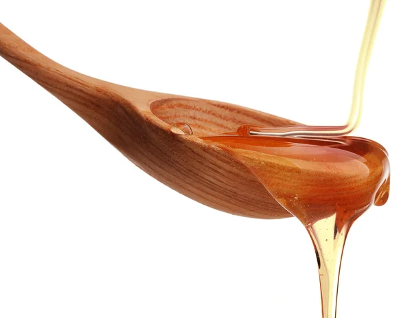 Honey dripping from spoon — Stock Photo, Image