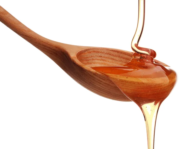 Honey dripping from spoon — Stock Photo, Image