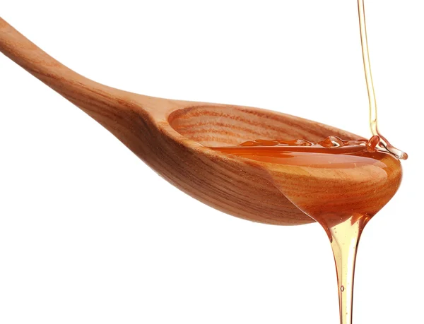 Honey dripping from spoon — Stock Photo, Image