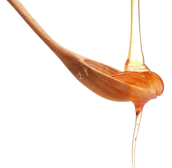 Honey dripping from spoon — Stock Photo, Image