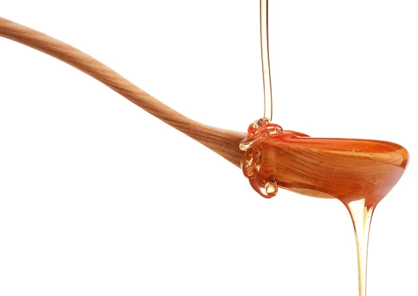 Honey dripping from spoon — Stock Photo, Image