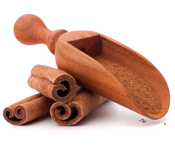 Cinnamon sticks and powder in wooden spoon — Stock Photo, Image