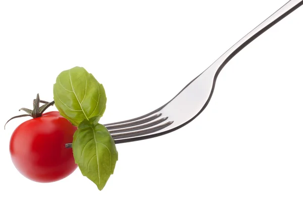 Basil leaf  and cherry tomato on fork — Stock Photo, Image