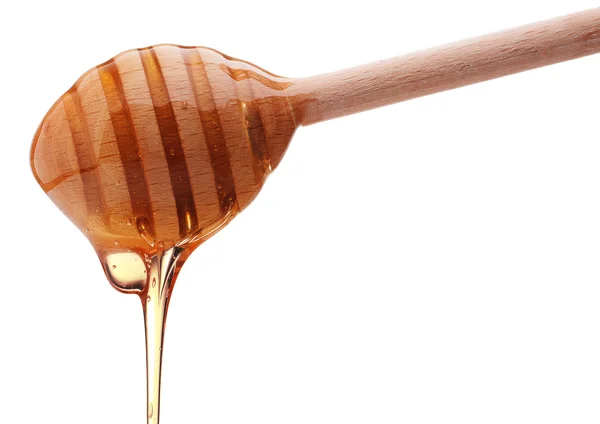 蜂蜜从木制蜂蜜搅拌器上滴下 — 图库照片
