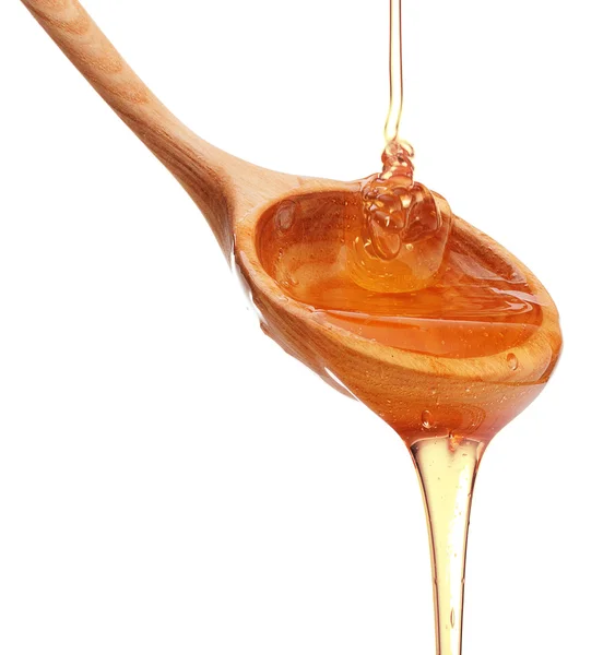 Miel goteando de un tarro de miel de madera — Foto de Stock