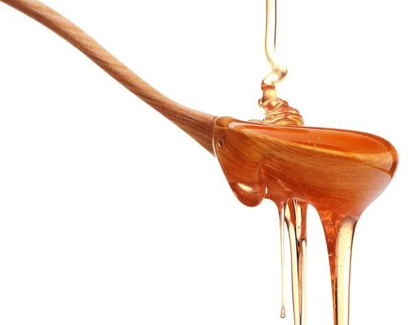 Miel goteando de cuchara de madera — Foto de Stock