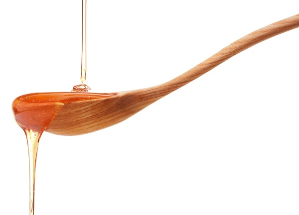 Honey dripping from spoon — Stock Photo, Image