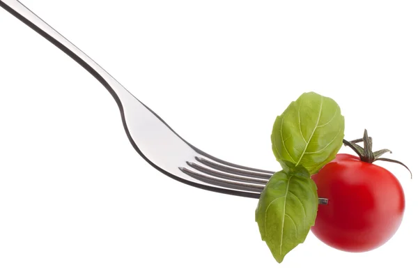Basilikumblatt und Tomate auf Gabel — Stockfoto
