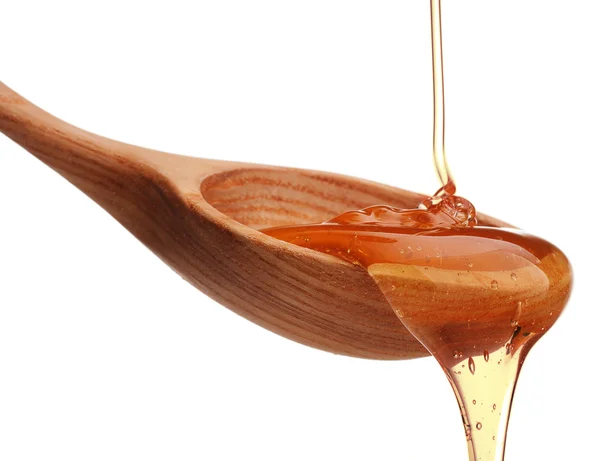 Miel dégoulinant sur cuillère en bois — Photo