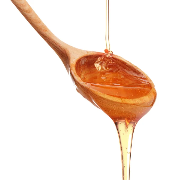 Μέλι στάζει σχετικά με ξύλινο κουτάλι — Φωτογραφία Αρχείου
