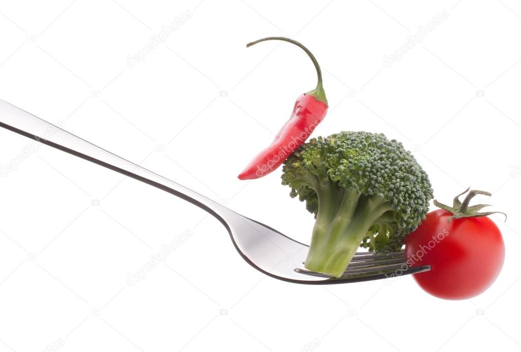 Fresh raw vegetables on fork