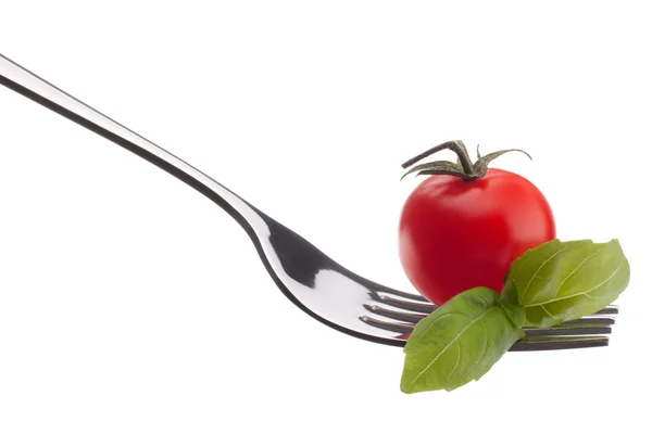 Basil leaves  and cherry tomato on fork — Stock Photo, Image