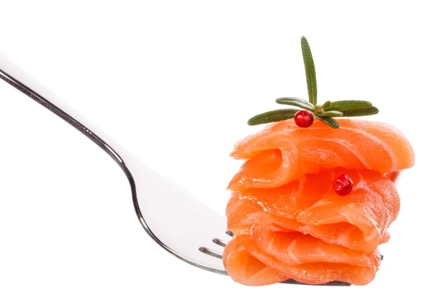 Salmon pieces with peppercorns on fork — Stock Photo, Image