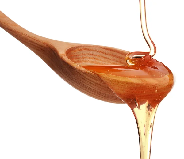 Spoon with pouring honey — Stock Photo, Image