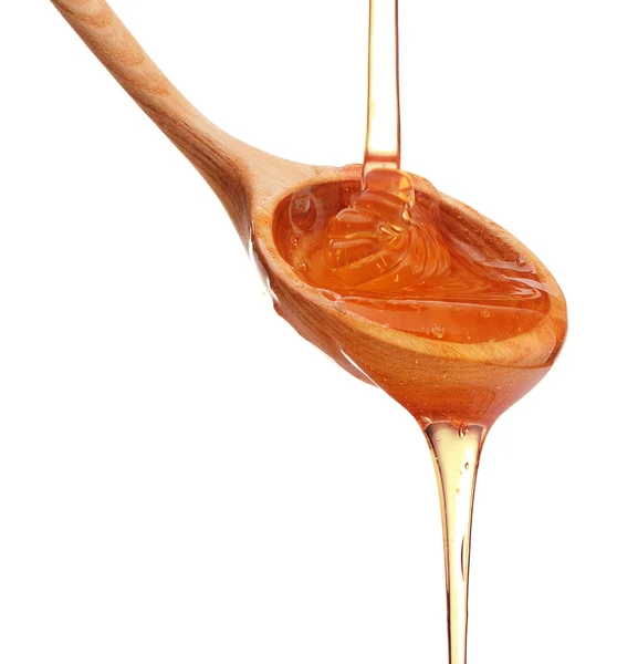 Löffel mit Honig gießen Stockbild
