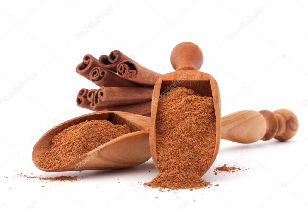 cinnamon sticks  and powder in wooden scoops