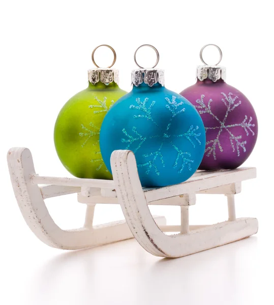 Christmas balls in sleds — Stock Photo, Image