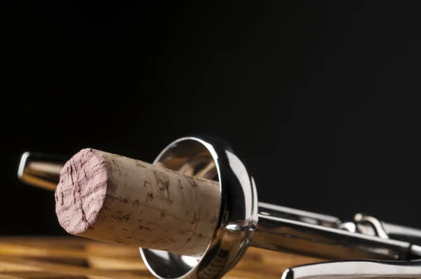 Wine cork in corkscrew on wooden table — Stock Photo, Image
