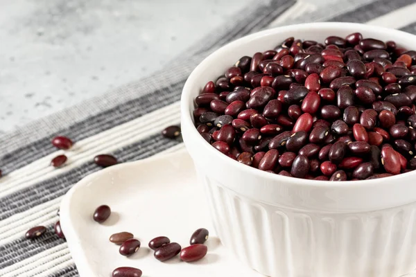 Red beans. Raw red beans in a ceramic bowl on a light gray kitchen table. Organic Natural Vegetarian product