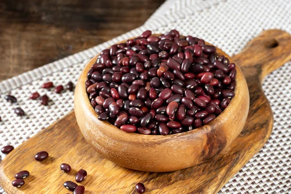 Red beans. Raw red beans in a wooden bowl on a brown wooden table. Organic Natural Vegetarian product