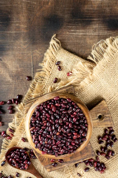 Red beans. Raw red beans in a wooden bowl on a brown wooden table. Organic Natural Vegetarian product