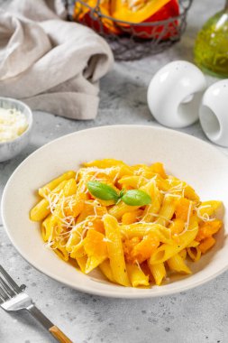 Açık gri mutfak arka planında seramik tabakta kabaklı Napoli makarna süslemesi. Geleneksel İtalyan mutfağı