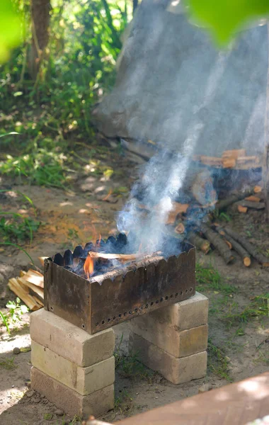 An empty blazing grill with an open fire, ready to place the product. Summer grill, barbecue, barbecue and party concept.