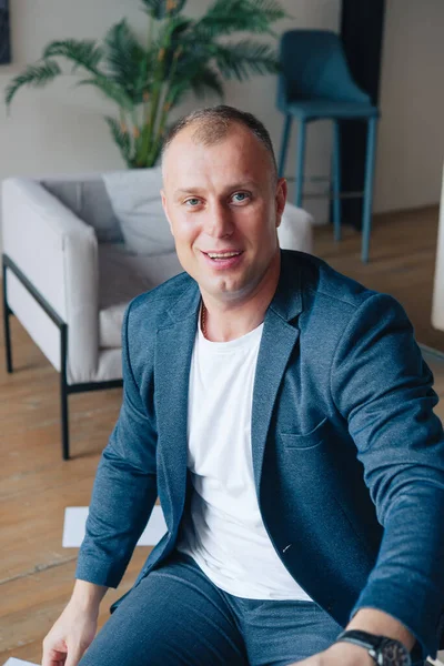 Ofiste oturan bir iş adamı dizüstü bilgisayarla çalışıyor. İş adamı portresi.