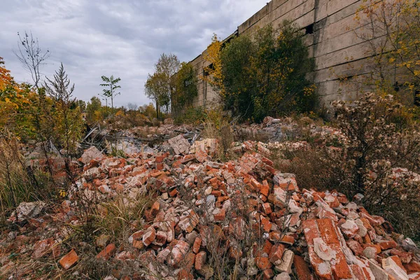 Remains of demolished old industrial building. Pile of stones, bricks and debris.