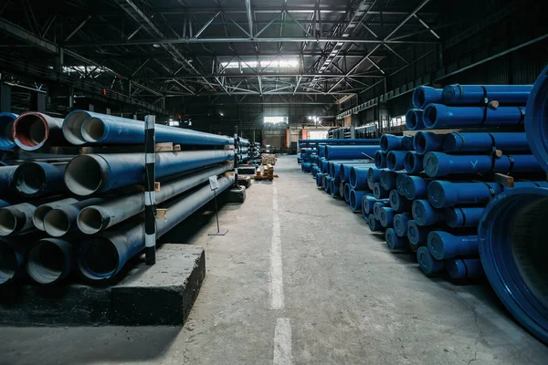 New cast iron pipes for pipeline construction in warehouse.