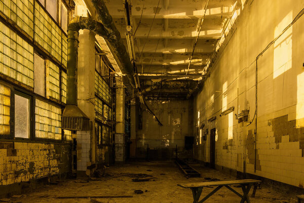 Dark creepy empty abandoned industrial building interior at night.