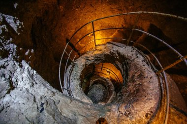Old ancient spiral staircase in the well Tik Kuyu, in Chufut Kale, Bakhchisaray, Crimea Bakhchisarai Crimea. clipart