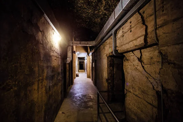 Dark creepy old corridor of underground bunker or prison.