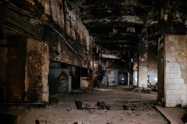 Burnt and ruined interior of industrial building after fire. Consequences of war, fire or other disaster.