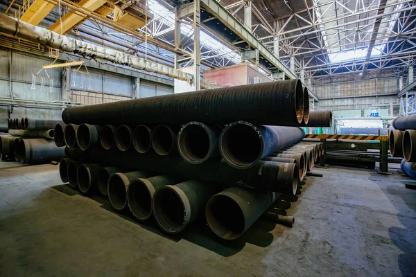 New cast iron pipes for pipeline construction in warehouse.