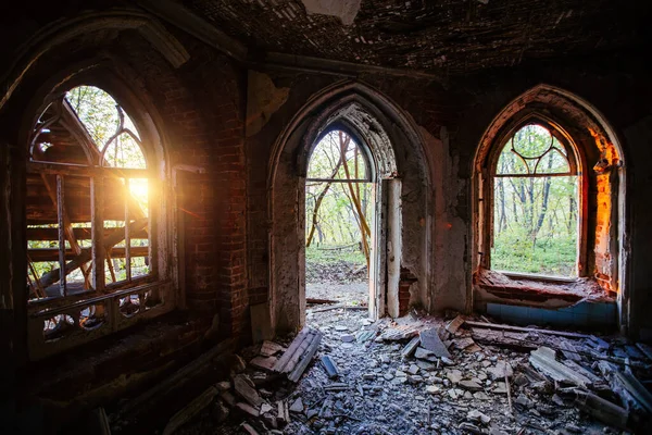 Inside old ruined abandoned historical mansion in Gothic style.