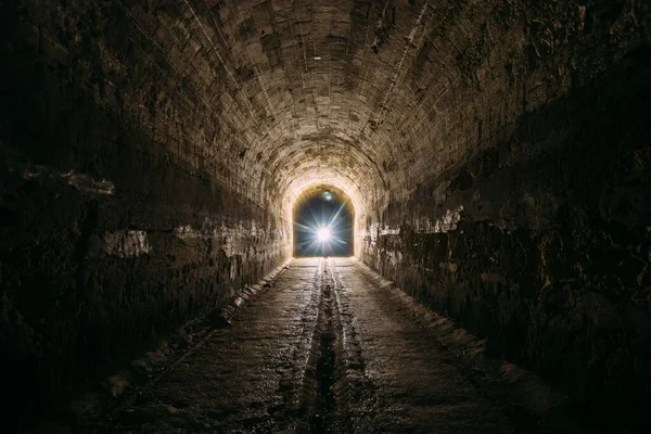 Dark and creepy old historical vaulted underground road tunnel.