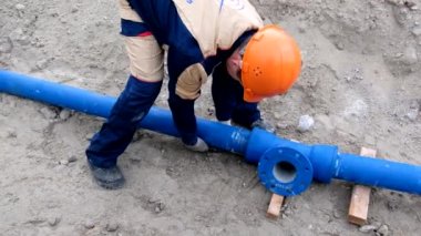 İşçi su tedarik boru hattı sistemi kuruyor