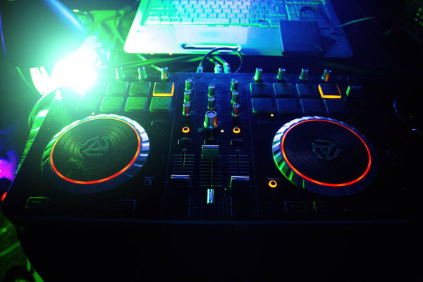 DJ equipment turntable console at in the night club.