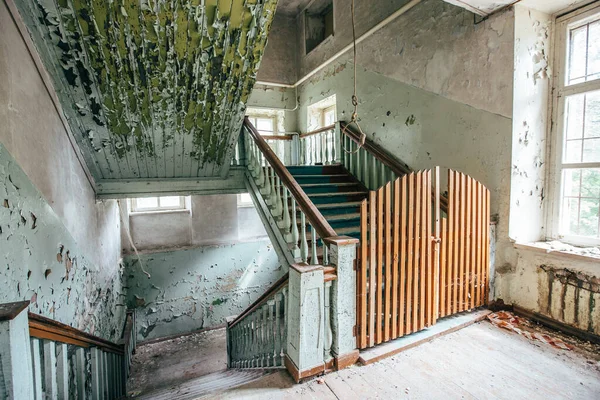 Hanging noose of rope in creepy abandoned building.