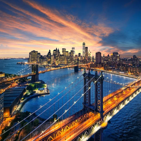 New york city - schöner sonnenuntergang über manhattan mit manhattan und brooklyn bridge Stockbild