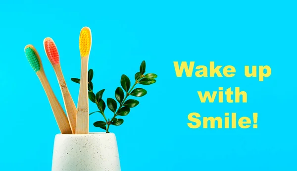 Cepillos Dientes Madera Con Una Taza Vidrio Sobre Fondo Azul —  Fotos de Stock