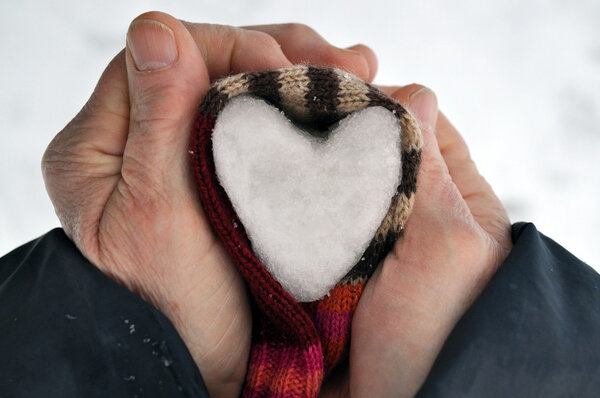 Heart of snow in hands