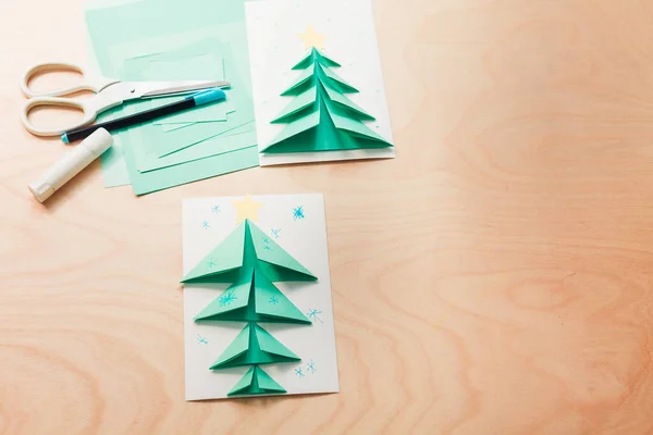 Christmas card, a stack of colored paper of different sizes, scissors and glue — Foto de Stock