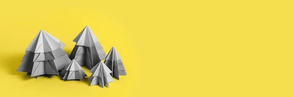 Simple origamy 3D Christmas tree made from gray paper on yellow backround — Φωτογραφία Αρχείου