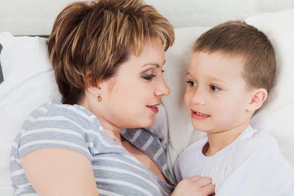 Mother talking with her little son — стокове фото