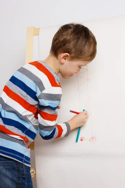 Child drawing a picture on easel — Stok fotoğraf