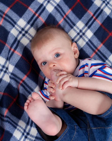 Cute baby nipping his feet — Stock Photo, Image